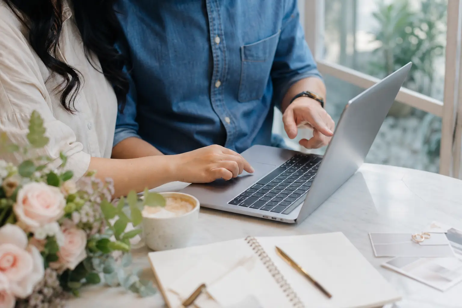 Couple planning their wedding together on a laptop